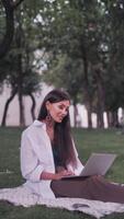 Happy young online teacher wears headset communicates with distant student gives web education class talks in webcam chat conference call on laptop screen. Elearning concept. Vertical video