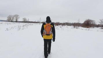 person walking in the snow with a backpack video