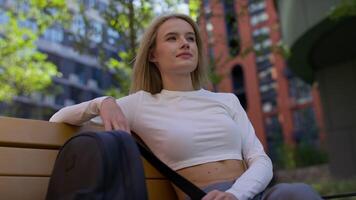 Woman Relaxing on Park Bench in Urban Setting video