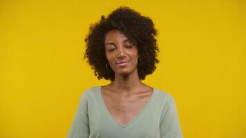 Joyful Woman Dancing Lightly Against Vibrant Yellow Background video