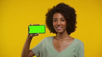 Confident young woman showing smartphone screen and nodding in approval video