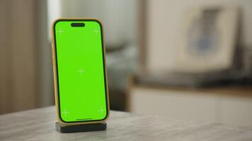 Smartphone with Green Screen for Chroma Key on Docking Station video