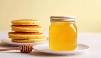 Natural honey bee on glass jar and white plate for natural organic sweetener photo