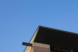 A close-up view of the rooftop edge of a high-rise building on a clear day. photo