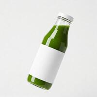 A glass bottle of green juice with a mock white label isolated on white photo