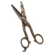 Old rusty metal scissors isolated on white photo