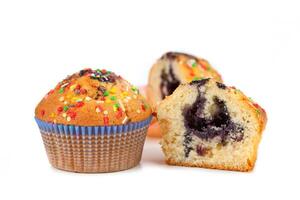 A blueberry muffin with sprinkles on a white background photo