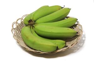 A green banana, after harvest, in a woven bamboo container, panen pisang cavendish, pisang ambon hijau, dari kebun, Ambon bananas, sweet, savory and a little sour, after harvest, rasanya manis gurih photo