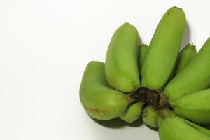 A green banana, after harvest, in a woven bamboo container, panen pisang cavendish, pisang ambon hijau, dari kebun, Ambon bananas, sweet, savory and a little sour, after harvest, rasanya manis gurih photo