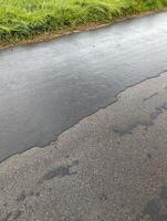 Deteriorating Asphalt and Concrete Road Surface in Wales photo