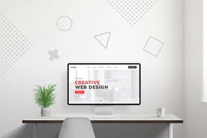 Web design studio presentation on modern computer display on work desk, accompanied by coffee mug and plant for a cozy workspace ambiance photo