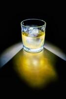 Glass of whiskey on the rocks photo