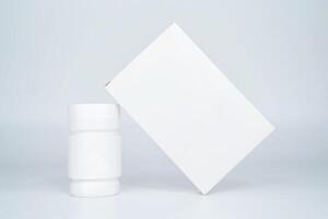 Medicine bottle and package separately on gray background photo