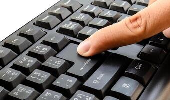 index finger push on keyboard photo