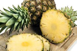 Slices of pineapples on a cutting board still life photo