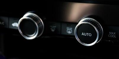 Button automatically adjust the air conditioning temperature in a modern car luxury interior 2024. Function control panel buttons in modern car. photo