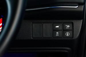 Close up of the car interior control panel buttons. Function control buttons in modern car, Safety system control panel buttons inside the car luxurious for modern cars in 2024. photo