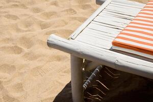 Beach chair with Sleeping pad on the white sand beach minimalism with copy space. Deckchair on the beach. Vacation, Beach, Travel, Relaxation concept. photo
