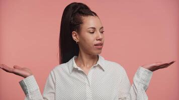 Woman Weighing Options with Playful Expression on Pink Background video