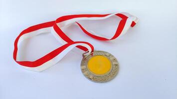 The winner's gold medal is held in the athlete's raised hand on a white background photo