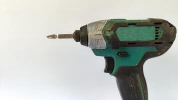 Cordless drill with drill bits, white background for copy space. photo