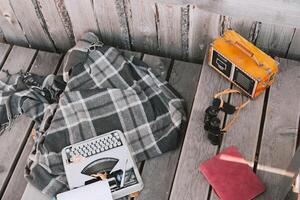 typewriter, blanket, radio and binoculars on a wooden floor. Workplace of a freelance writer against the background of a wooden house and floor photo