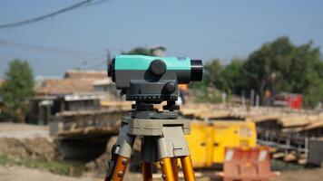 Automatic level usse for measuring level on construction site.Ensure precise measurements before undertaking construction projects. photo