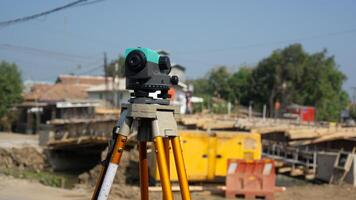 Automatic level usse for measuring level on construction site.Ensure precise measurements before undertaking construction projects. photo