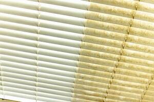 Residential Window Shades Showing the Before and After of a Good Cleaning - One Side Clean and One Side Dirty. photo