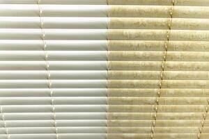 Residential Window Shades Showing the Before and After of a Good Cleaning - One Side Clean and One Side Dirty. photo