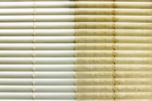 Residential Window Shades Showing the Before and After of a Good Cleaning - One Side Clean and One Side Dirty. photo