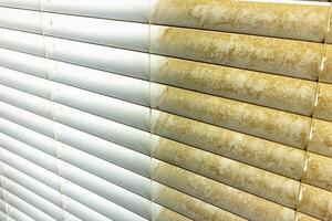 Residential Window Shades Showing the Before and After of a Good Cleaning - One Side Clean and One Side Dirty. photo