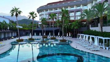 Tropical hotel pool with sunbeds and palm trees 10.20.2024 video