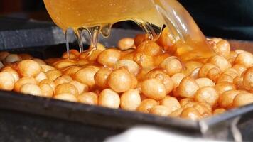 Enjoying delicious fried snacks at a street market in the evening video