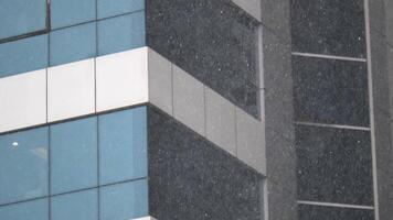 Snowfall blanketing urban buildings in downtown area video