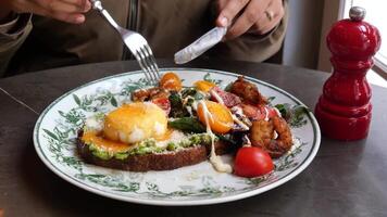 Enjoying a healthy breakfast with eggs and vegetables at a cafe video