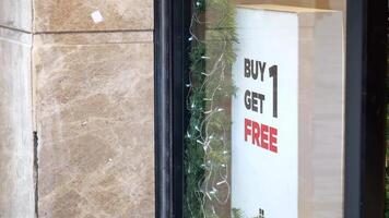 Buy one get one free promotion displayed outside store for customers video