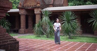 Handheld shot, Solo female tourist enjoys strolling around to appreciate the serene surroundings and the cultural richness of the place. Traveling and vacation concept. video