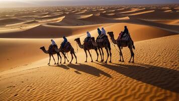 A caravan of camels traversing sand dunes under a golden sky. photo