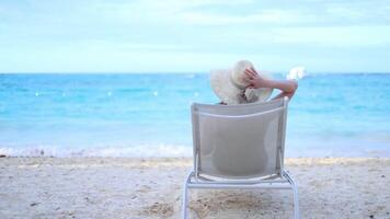 Relaxing on the beach while enjoying the ocean breeze and sunlight at a coastal paradise video