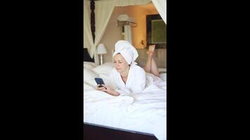 Relaxing morning in bed while checking messages and enjoying leisure time video