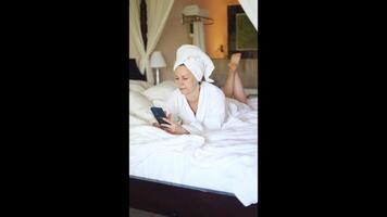Relaxing in a hotel room while using a smartphone in a cozy setting video