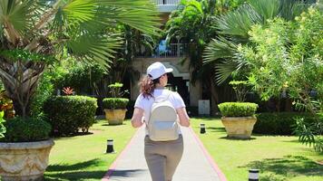 Exploring a lush garden pathway in a tropical resort during a sunny afternoon video