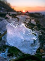 Sunset over the sea, which is covered with ice photo