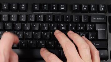 A person typing on a keyboard with black keys video