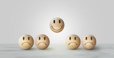 Smile icon wooden ball, sad face in dark side on wooden block cube for positive mindset selection. Concept of recruiting photo