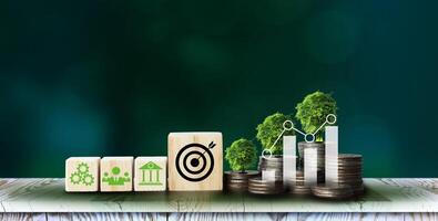 ESG icon concept in cube blocks and coin, graph, tree, for environmental, social, and governance in sustainable and ethical business on the Network connection on a green background. photo