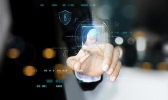 a person in a suit pressing a finger on a touch screen photo