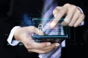 Man in a suit is holding a smartphone with a padlock on it photo