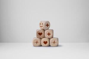 Wood cube stacking with heart health, emotion face icon. World mental health day concept photo